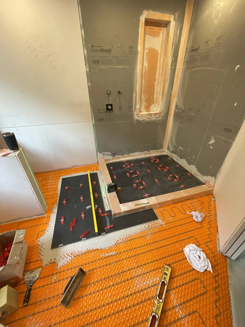 Porcelain floor tile going down over the heated floor membrane