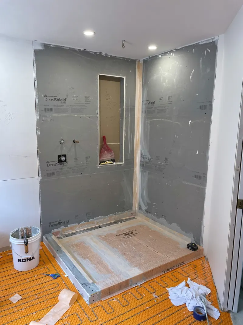 Shower walls covered in waterproof wallboard with sealed joints