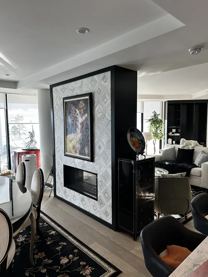 New marble fireplace surround beside a black column