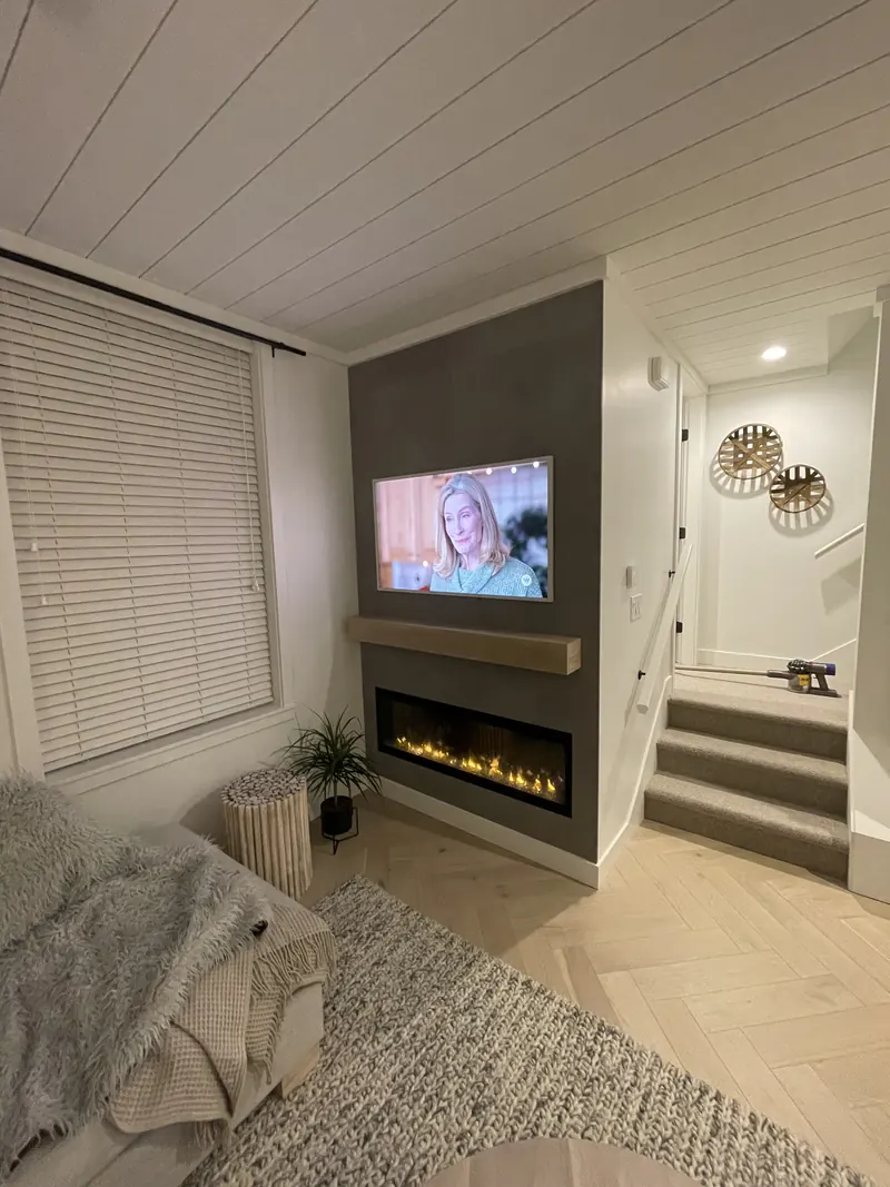 Feature wall with a linear fireplace and recessed television