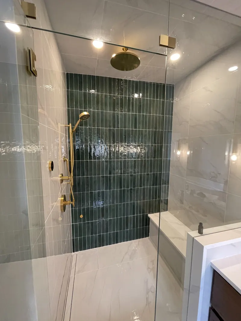 Green vertical tile feature wall in a glass shower